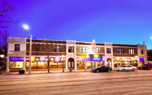 The whole building of Blueberry Hill Restaurant & Music club viewed from across the street. It takes up the whole block and features many bright neon signs.