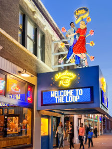 Exterior of Blueberry Hill Restaurant and Music Club with its big neon sign. People are walking along the street