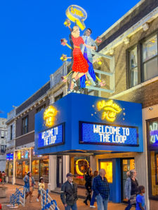 Exterior of Blueberry Hill Restaurant and Music Club with its big neon sign. People are walking along the street