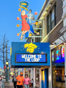 Exterior of Blueberry Hill Restaurant and Music Club with its big neon sign. People are walking along the street